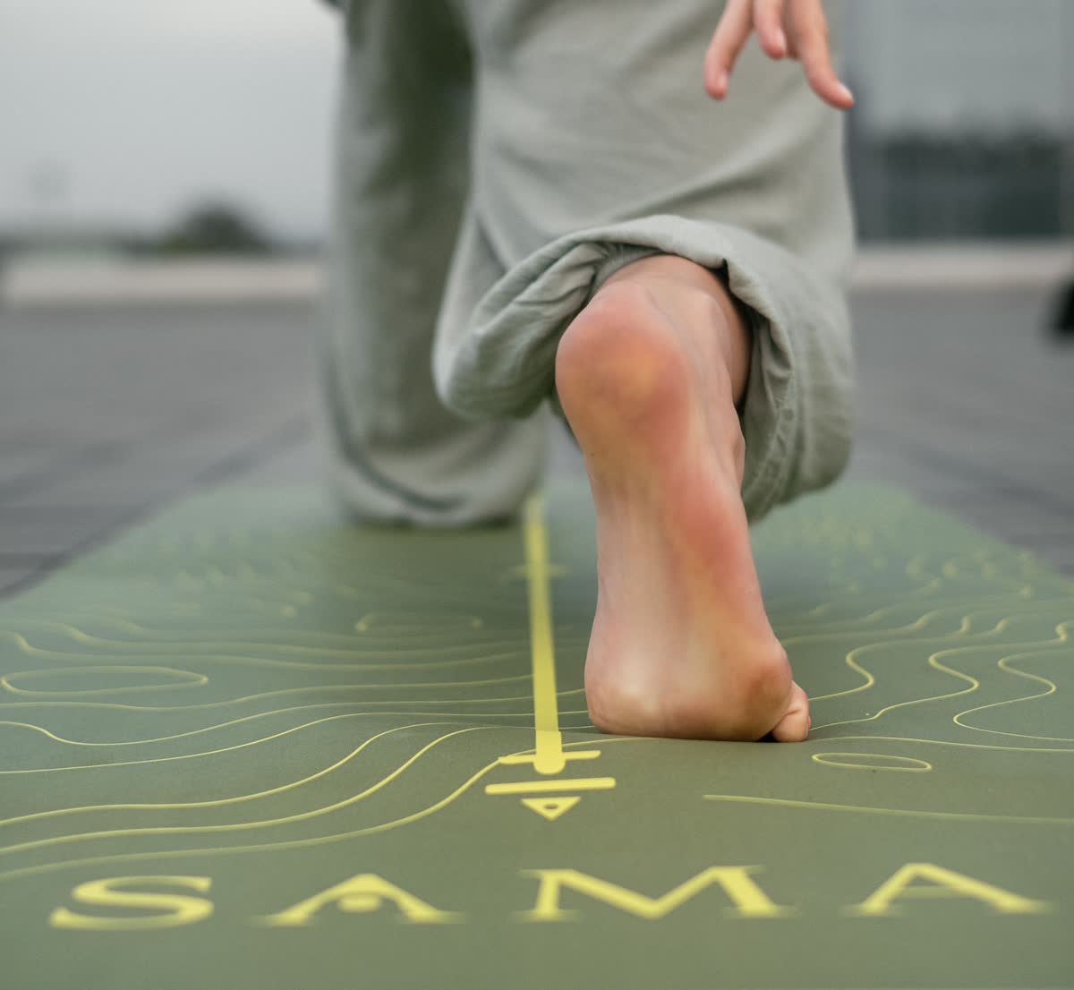 A grounded step onto a SAMA mat, representing mindful movement